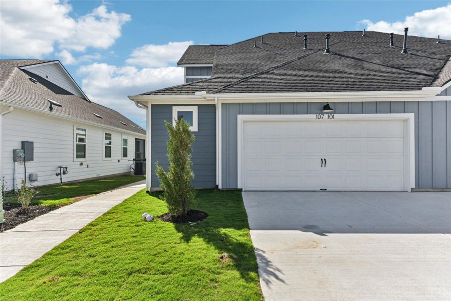 View of front of home featuring a garage, board and batten siding, concrete driveway, a front lawn, and roof with shingles View of front of home featuring a garage, board and batten siding, concrete driveway, a front lawn, and roof with shingles