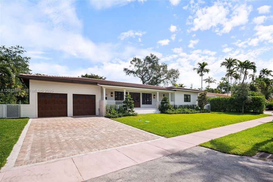 Front exterior of a new home in , Coral Gables, FL, highlighting curb appeal (Image 1). Front exterior of a new home in , Coral Gables, FL, highlighting curb appeal (Image 1).