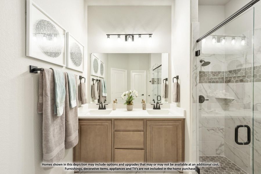 Bathroom with double sink vanity, wood cabinets, large mirror, and glass-enclosed marble tile shower. Bathroom with double sink vanity, wood cabinets, large mirror, and glass-enclosed marble tile shower.