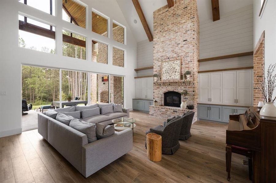 Main living room with high efficiency wood burning fireplace & circulation fan. Custom millwork.