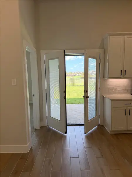 Double doors with built-in blinds open to your spacious patio & tranquil pond view!
