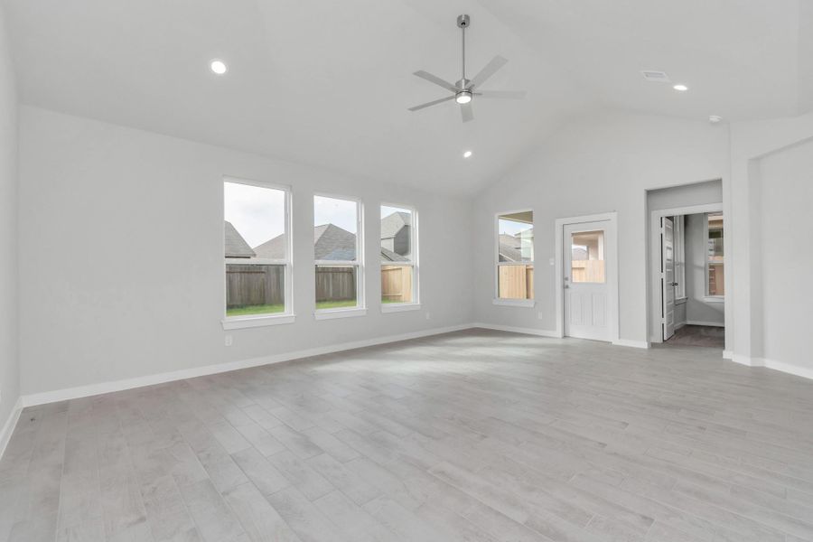 Bring your loved ones and guests together in the inviting living room! Boasting lofty high ceilings, recessed lighting, a stylish ceiling fan, custom paint, stunning flooring, and expansive windows that flood the space with ample natural light all day long. Sample photo of completed home with similar floor plan. As-built interior colors and selections may vary. Bring your loved ones and guests together in the inviting living room! Boasting lofty high ceilings, recessed lighting, a stylish ceiling fan, custom paint, stunning flooring, and expansive windows that flood the space with ample natural light all day long. Sample photo of completed home with similar floor plan. As-built interior colors and selections may vary.