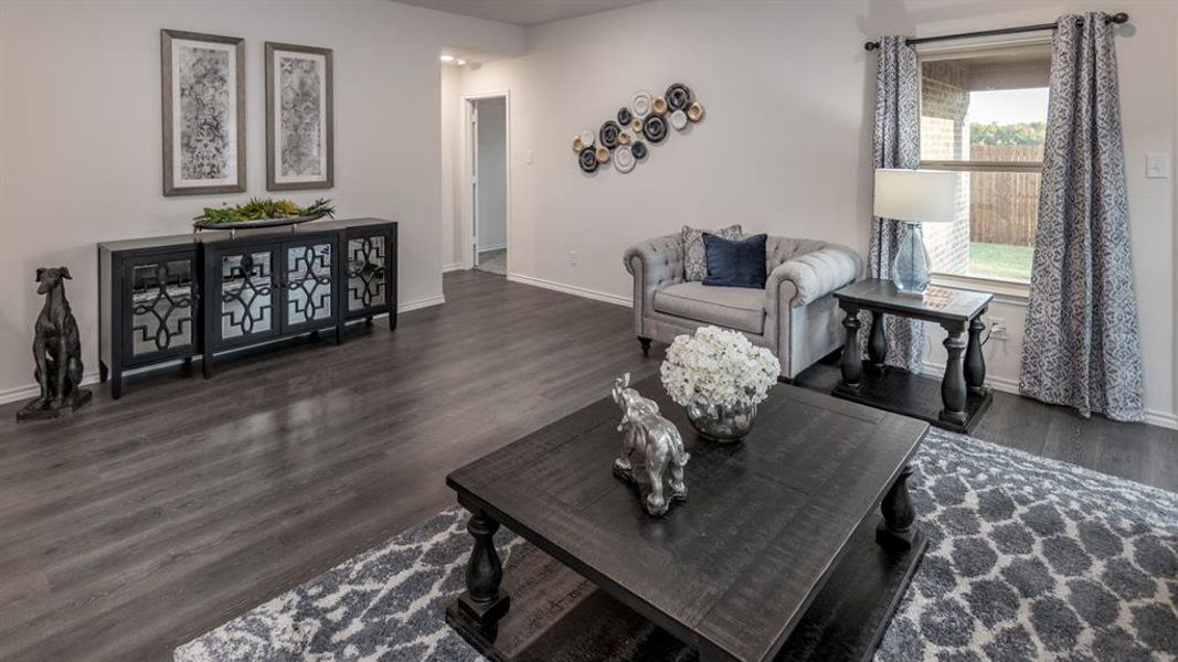 Living room with dark wood finished floors and baseboards