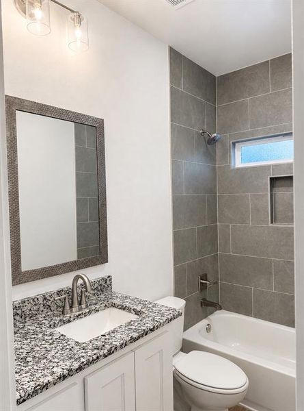 Bathroom featuring a vanity with a granite countertop, undermount sink, and brushed nickel faucet Bathroom featuring a vanity with a granite countertop, undermount sink, and brushed nickel faucet