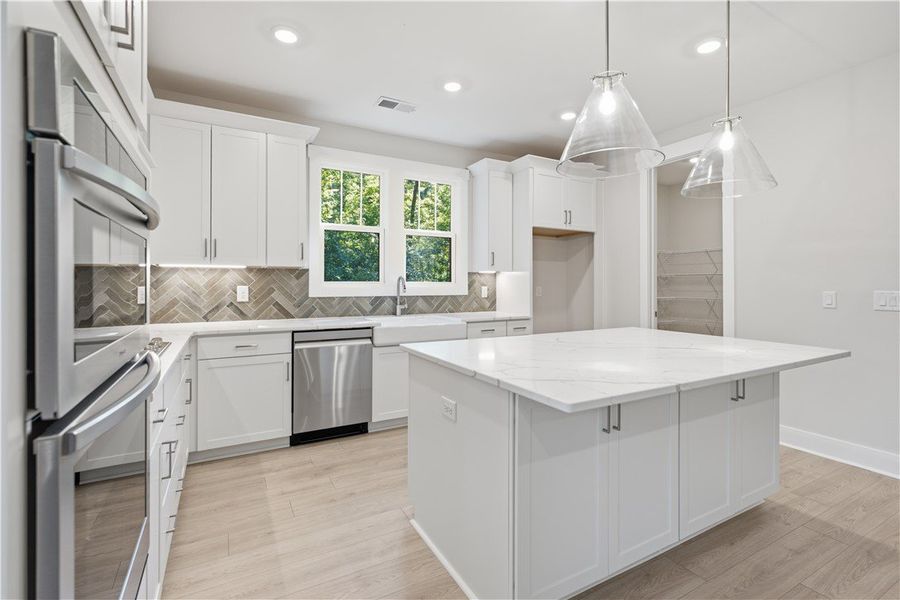 Gleaming stone countertops and a spacious central