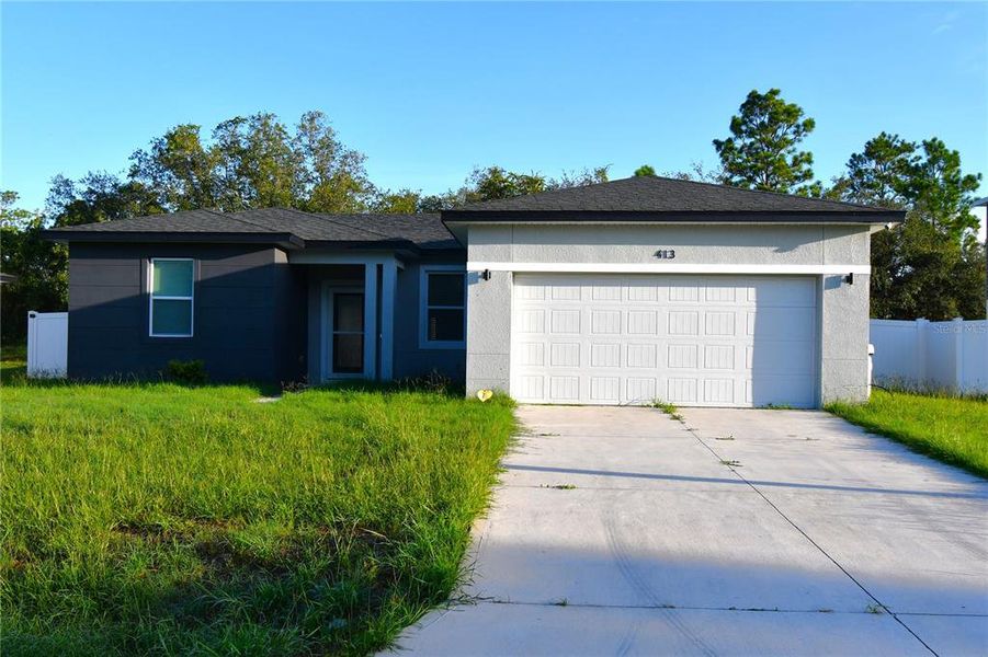Front exterior of a new home in , Poinciana, FL, highlighting curb appeal (Image 2). Front exterior of a new home in , Poinciana, FL, highlighting curb appeal (Image 2).