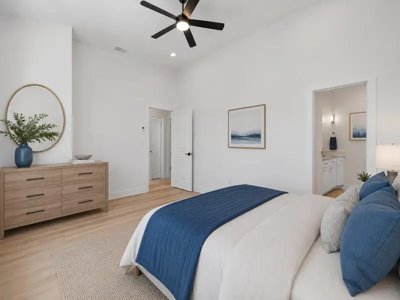 Bedroom suite featuring elevated ceilings, warm wood flooring and a serene contemporary atmosphere