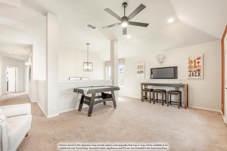 Game room with air hockey table, ceiling fan, vaulted ceiling, and carpet flooring Game room with air hockey table, ceiling fan, vaulted ceiling, and carpet flooring