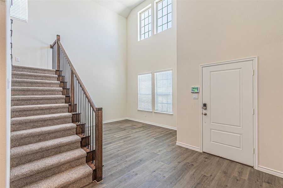 Entryway featuring a towering ceiling and hardwood / wood-style floors