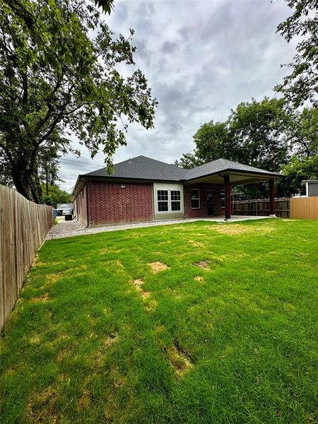 Back of property featuring a lawn