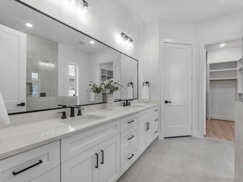 Dual vanity, full length framed mirror in the primary bath Dual vanity, full length framed mirror in the primary bath