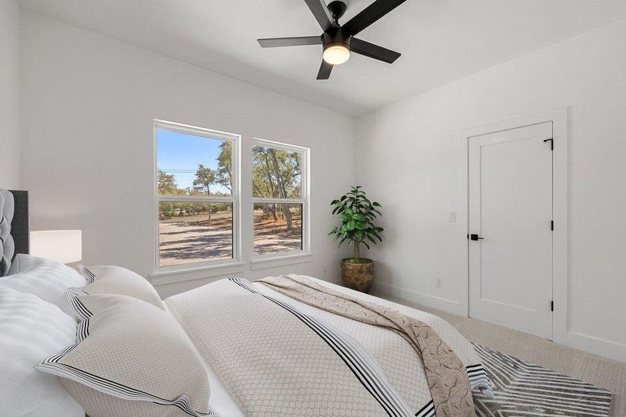 Bedroom featuring a ceiling fan and carpet floors
