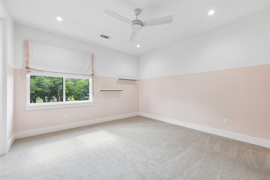 Carpeted spare room featuring ceiling fan