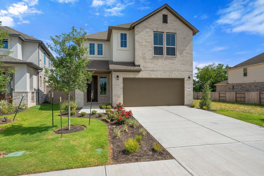 Front exterior of a new home in Flora, Hutto, TX, highlighting curb appeal (Image 28). Front exterior of a new home in Flora, Hutto, TX, highlighting curb appeal (Image 28).