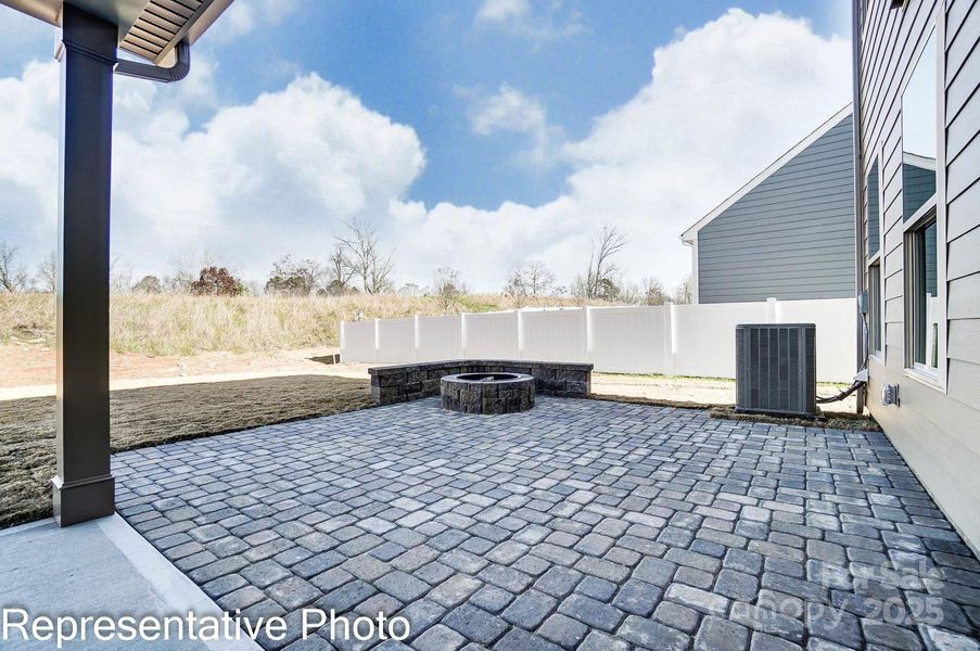 This home features a screened porch and paver patio with firepit