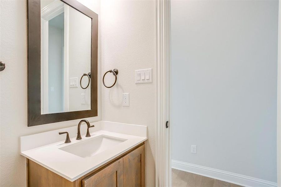 Bathroom with vanity and hardwood / wood-style floors