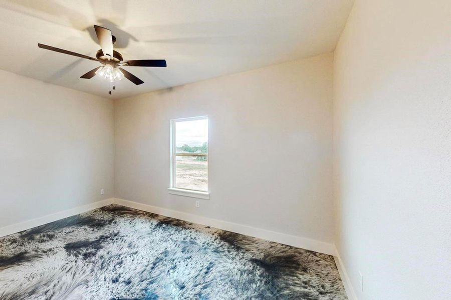 Empty room featuring ceiling fan