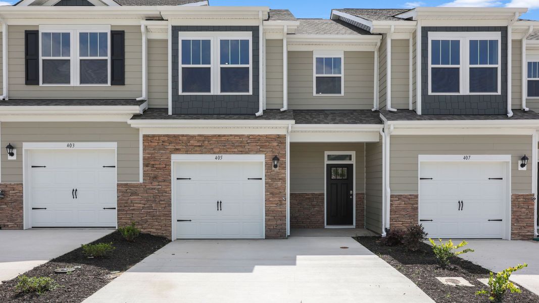 Front exterior of a new home in The Townes at Stonecrest, Hendersonville, NC, highlighting curb appeal (Image 1). Front exterior of a new home in The Townes at Stonecrest, Hendersonville, NC, highlighting curb appeal (Image 1).