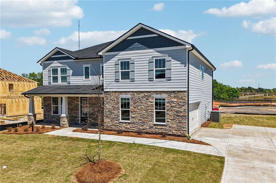 Front exterior of a new home in River Pointe, Monroe, GA, highlighting curb appeal (Image 28).