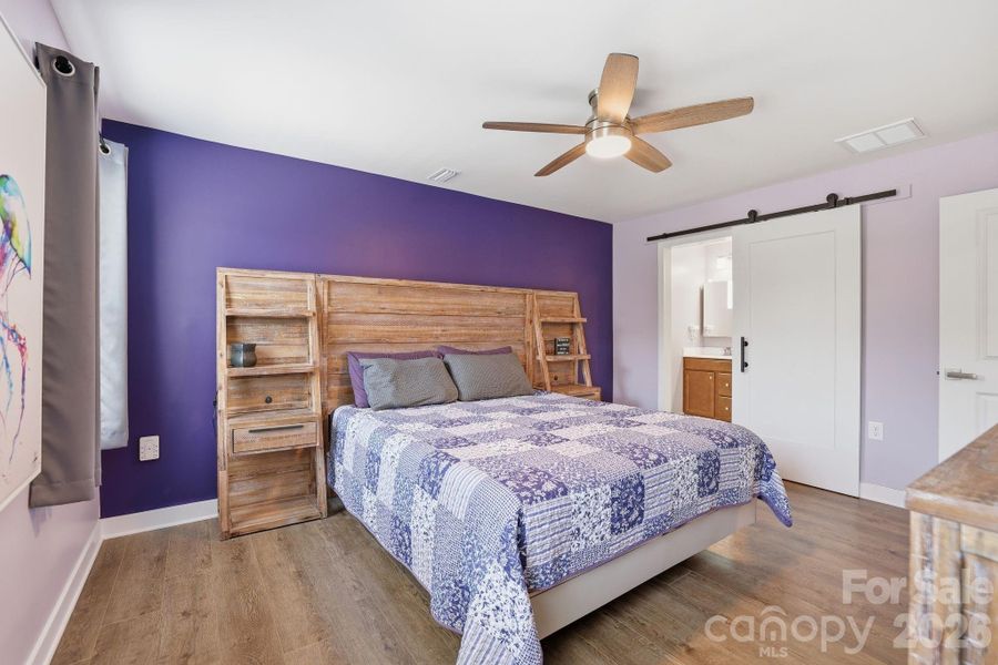 Barn door leads to the primary bath