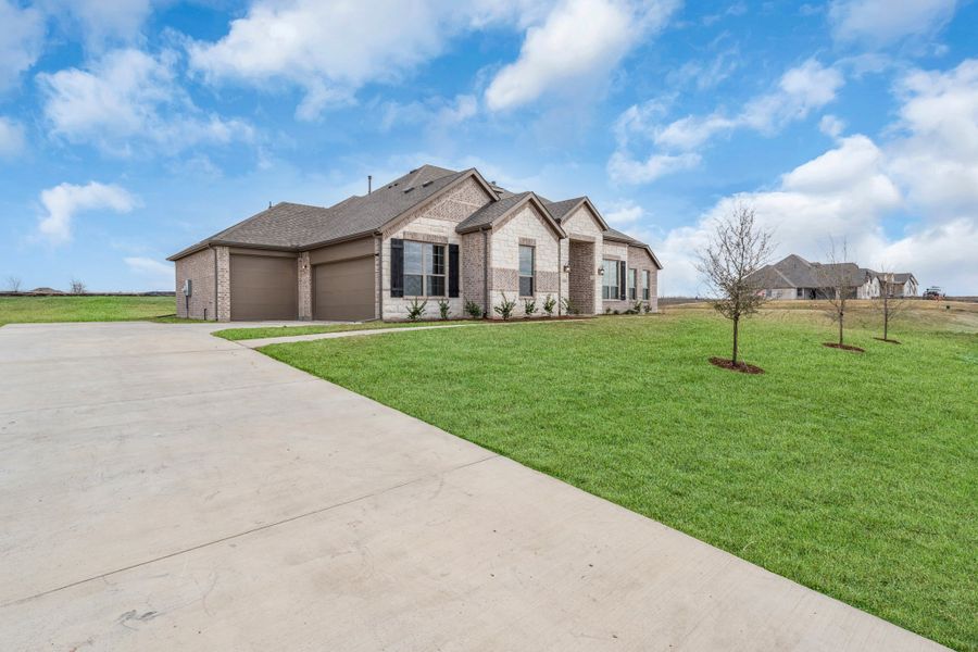 Front exterior of a new home in Berkshire Estates, Mesquite, TX, highlighting curb appeal (Image 24). Front exterior of a new home in Berkshire Estates, Mesquite, TX, highlighting curb appeal (Image 24).