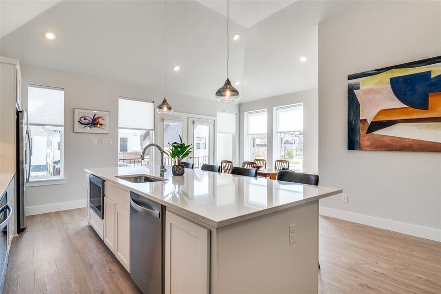 The huge quartz kitchen island doubles as a breakfast bar and an additional seating area.