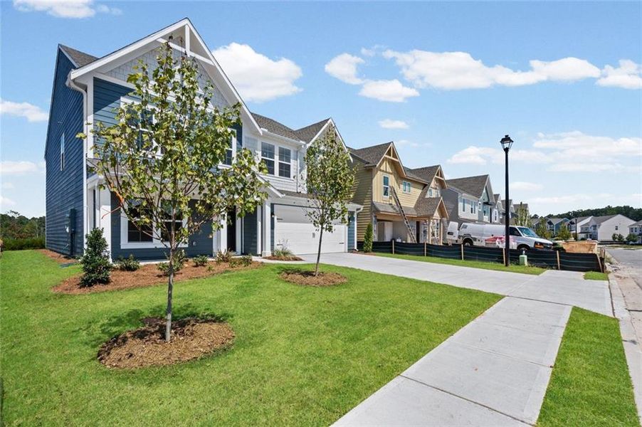 Front exterior of a new home in Twin Lakes, Hoschton, GA, highlighting curb appeal (Image 2). Front exterior of a new home in Twin Lakes, Hoschton, GA, highlighting curb appeal (Image 2).