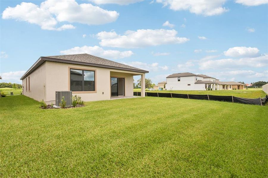 Front exterior of a new home in Grasslands West, Lakeland, FL, highlighting curb appeal (Image 10). Front exterior of a new home in Grasslands West, Lakeland, FL, highlighting curb appeal (Image 10).