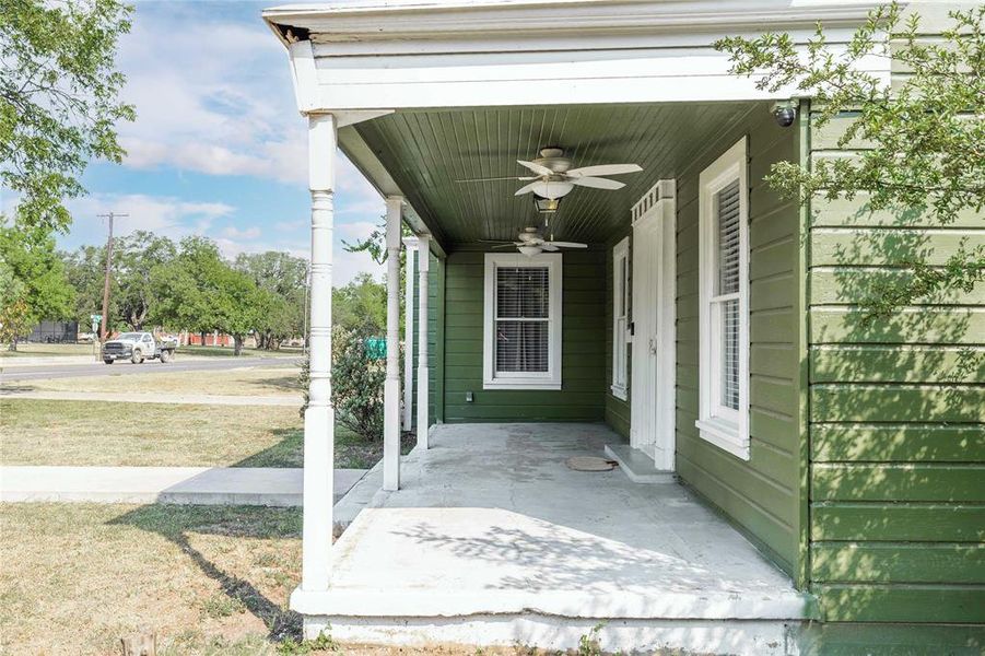 Entrance to property featuring covered porch and a ceiling fan Entrance to property featuring covered porch and a ceiling fan