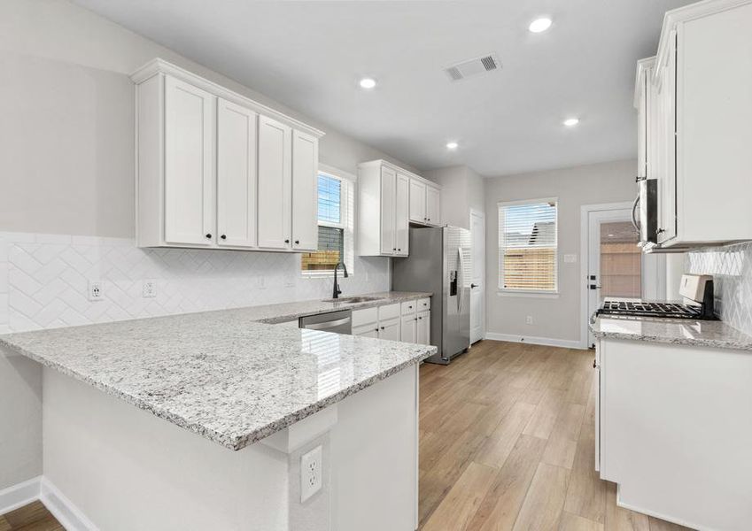 This kitchen features gorgeous countertops.