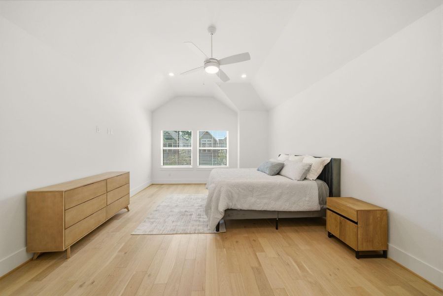 Serene primary retreat withsoaring ceilings, beautiful woodflooring, and generous spacedesigned for comfort andrelaxation. (Photo of a previous build, similar finishes.)