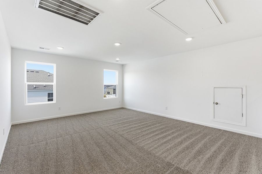 A room with white walls and a carpeted floor.