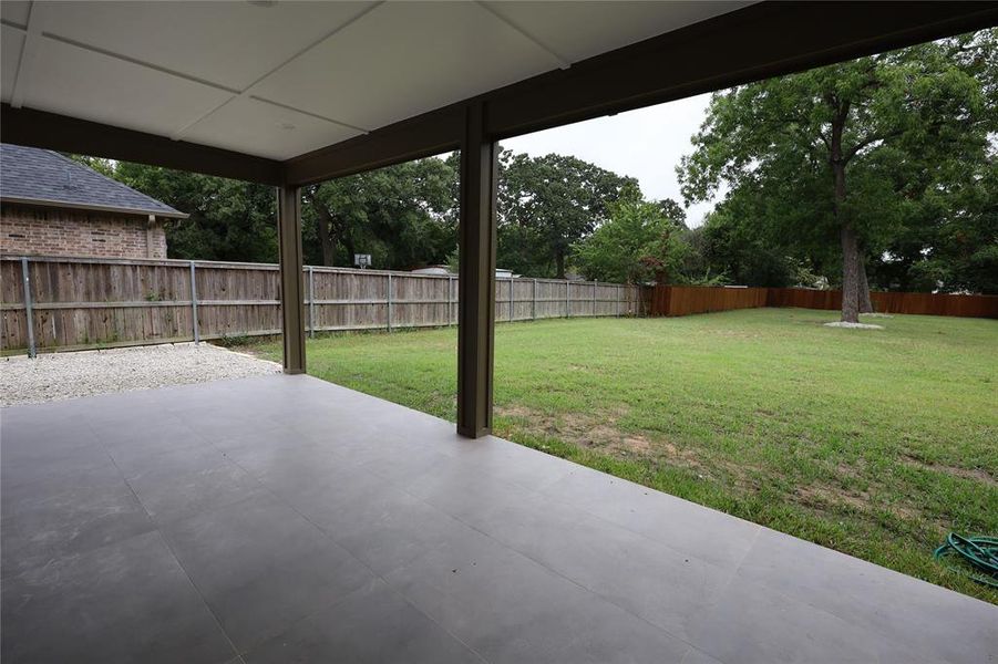 Fenced backyard with a patio