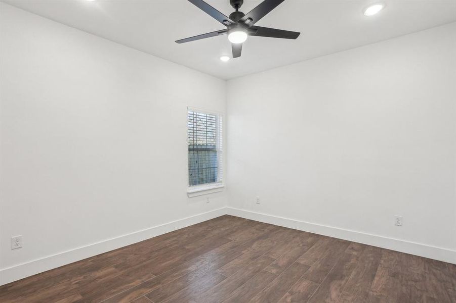 Side Bedroom 3 featuring ceiling fan and dark hardwood / wood-style flooring