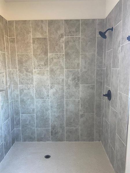 Bathroom featuring tiled shower