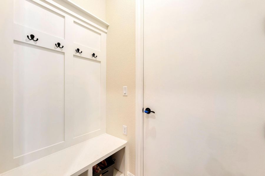 A built-in bench and coat rack offer convenient storage and organization. A built-in bench and coat rack offer convenient storage and organization.