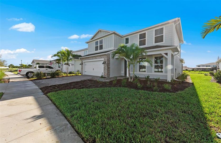 Front exterior of a new home in SeaFlower, Bradenton, FL, highlighting curb appeal (Image 20).