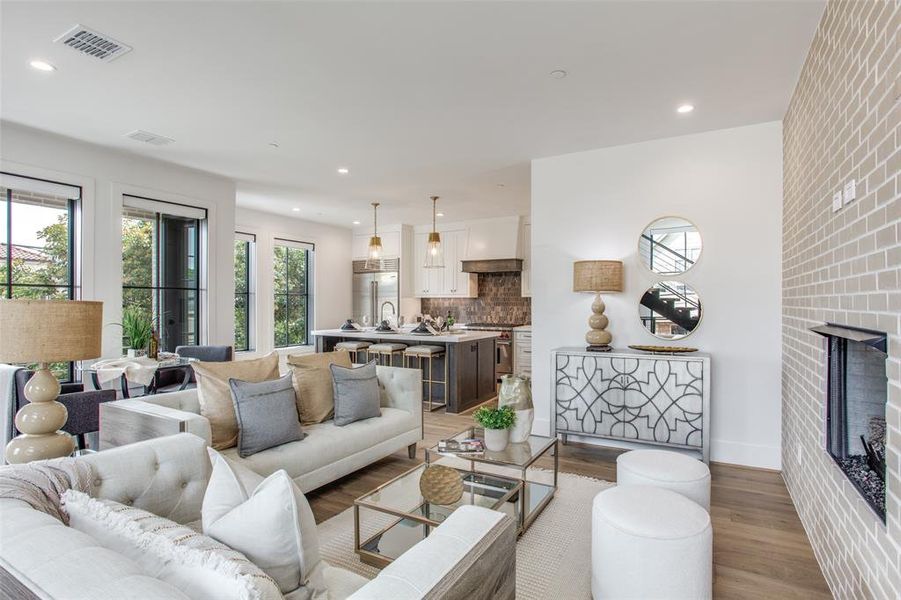 Living room featuring a brick fireplace and light hardwood / wood floors