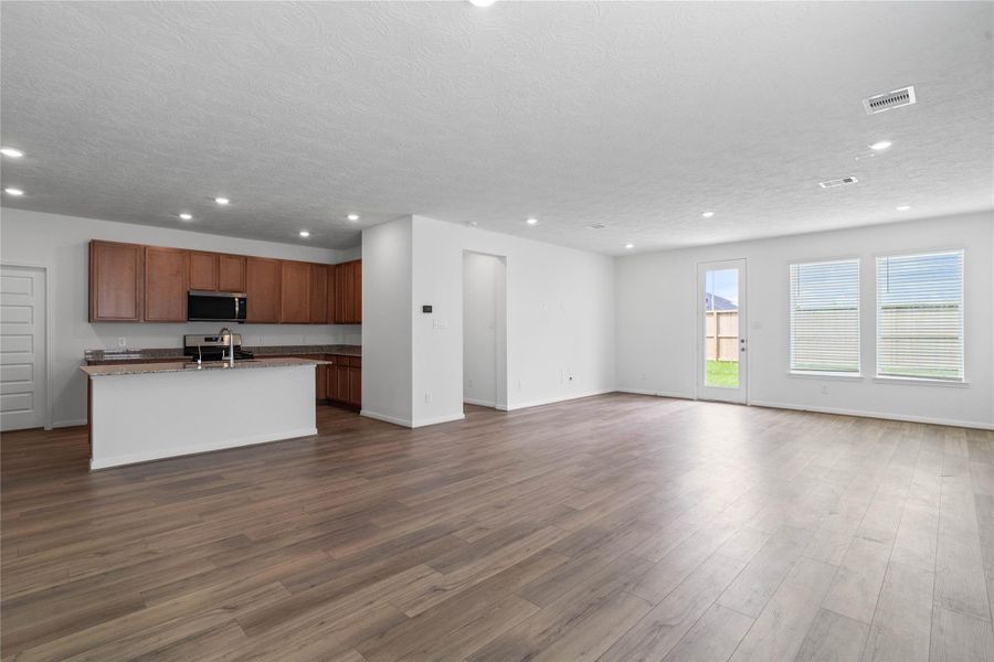 Stunning open-concept design seamlessly connecting the living, dining, and kitchen areas—perfect for both everyday living and entertaining!