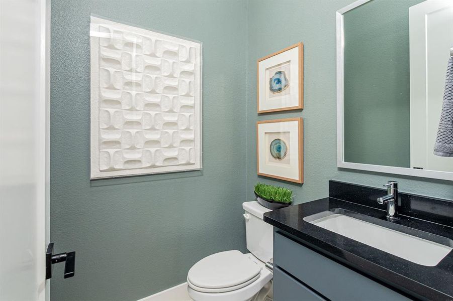 Bathroom with vanity and a textured wall