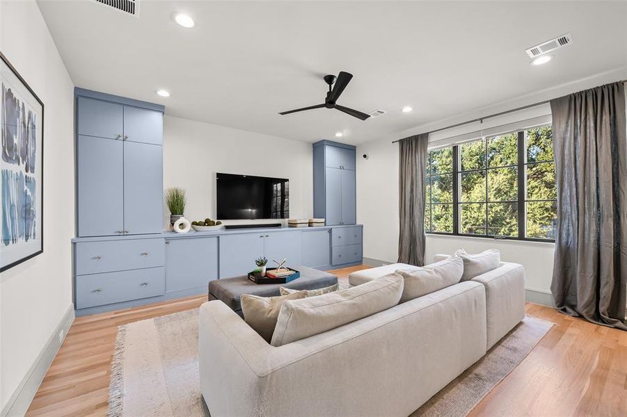 Second floor living area with built-in cabinetry and oak wood floors.