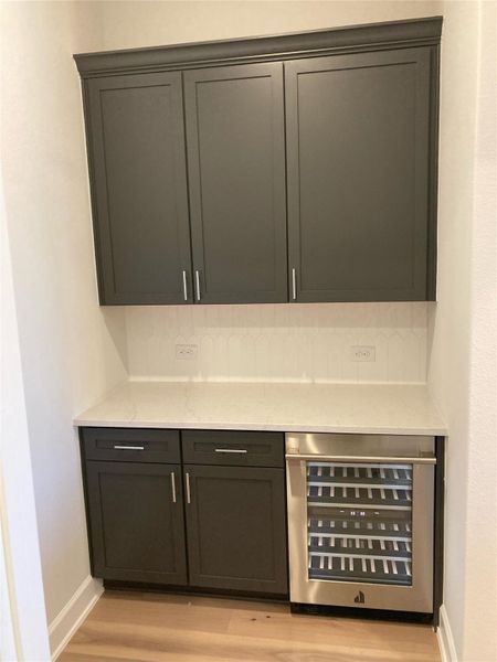 Butler pantry with extra counter/cabinet space and a wine chiller