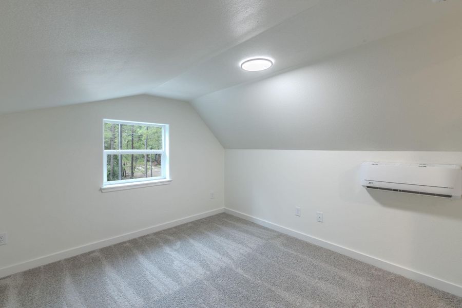 A well-lit attic space offers flexible living with sloped ceilings and ample natural light. A well-lit attic space offers flexible living with sloped ceilings and ample natural light.