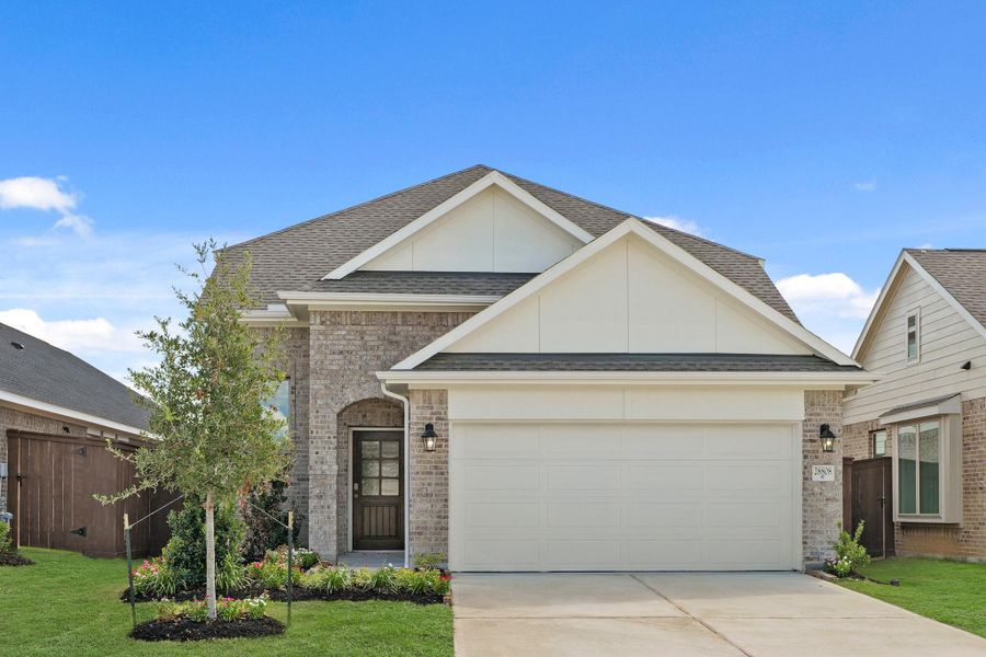 Front exterior of a new home in The Trails, New Caney, TX, highlighting curb appeal (Image 20).