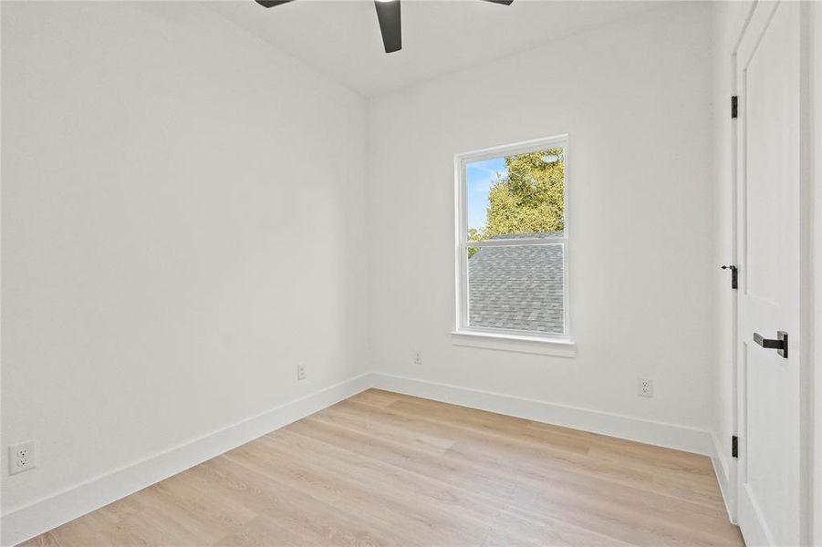 Unfurnished bedroom with light wood-style flooring and ceiling fan
