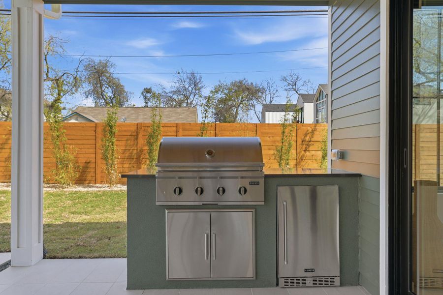 Fenced backyard featuring area for grilling and a patio area