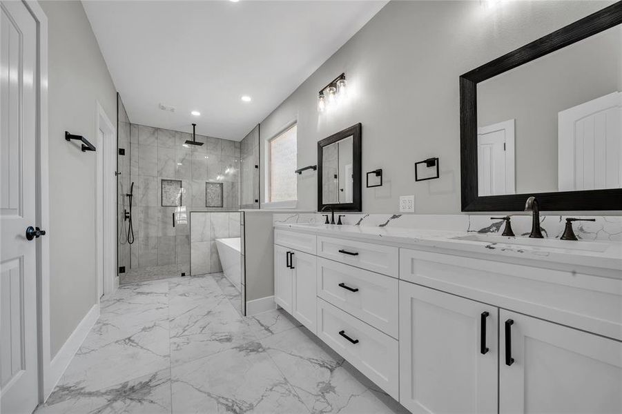 Bathroom with tile patterned floors, double sink vanity, and plus walk in shower