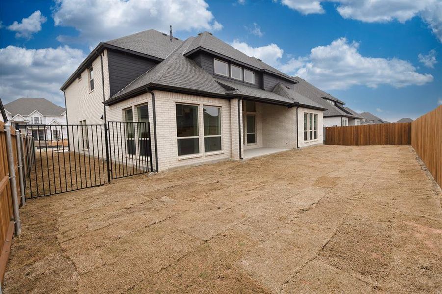 Rear view of property featuring a lawn