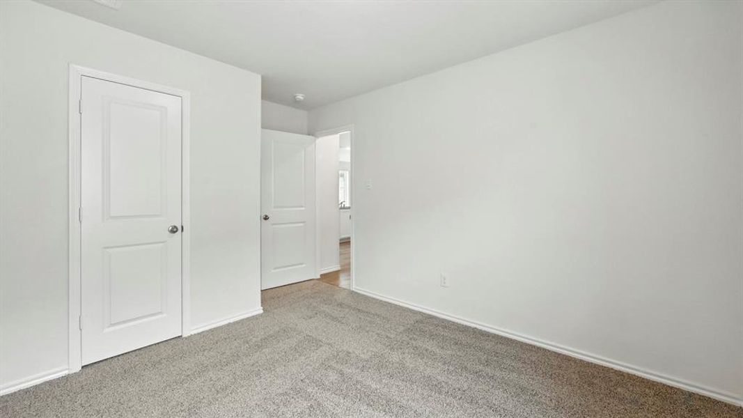 Interior room featuring light gray carpet flooring and white painted walls Interior room featuring light gray carpet flooring and white painted walls