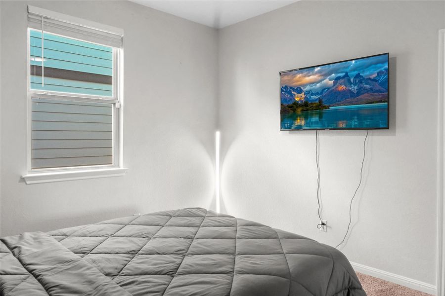 Carpeted bedroom featuring baseboards